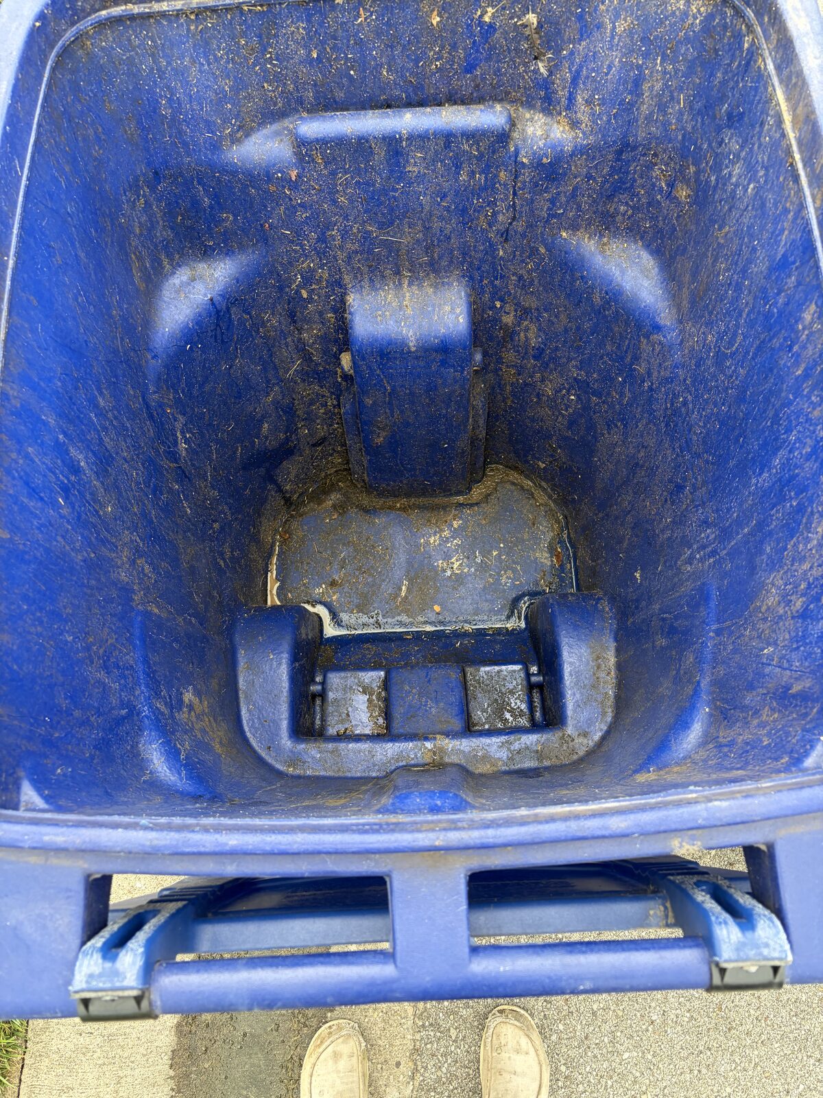 Dirty 96-gallon trash can interior, caked with debris before Bin Brilliant cleaning
