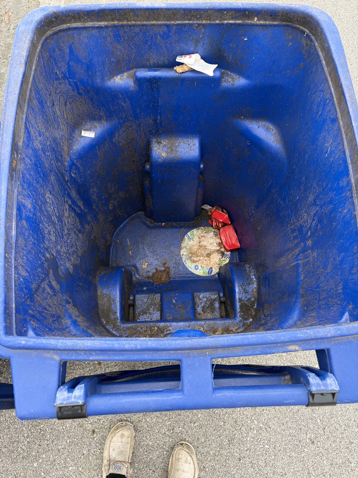 Trash can with food residue and stuck-on debris before cleaning